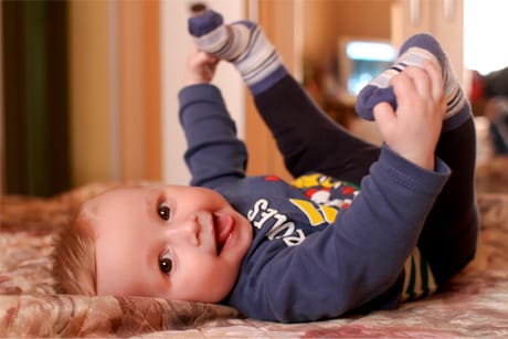 A baby lying on a bed
