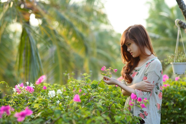 woman holding flower in nature